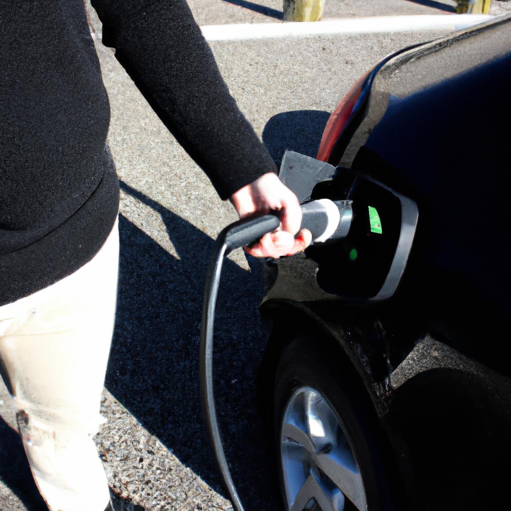 Person using electric vehicle charger