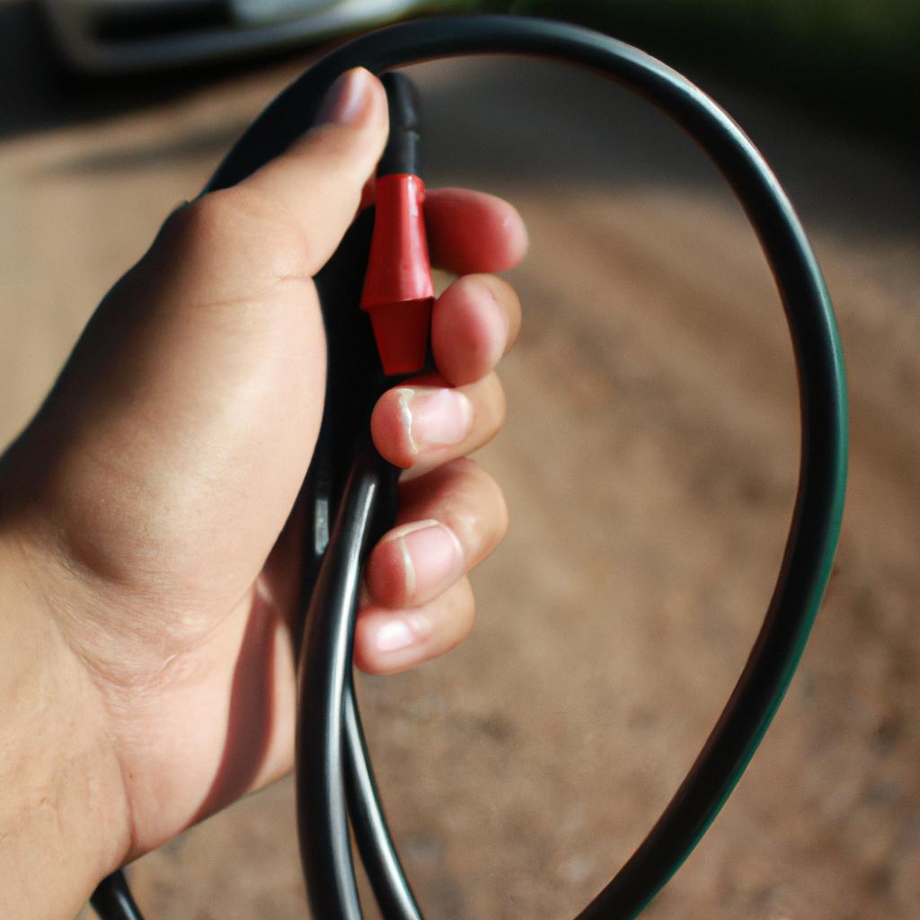 Person holding car charging cable